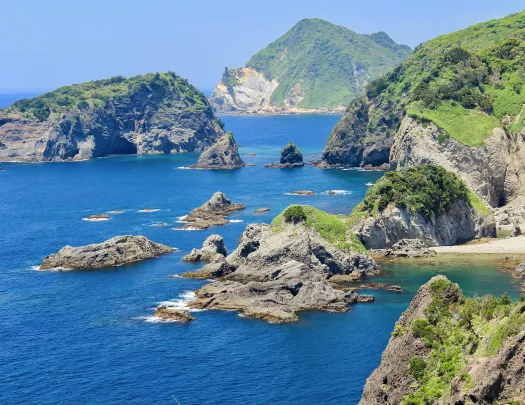 Ocean with large cliffs and boulders to the right