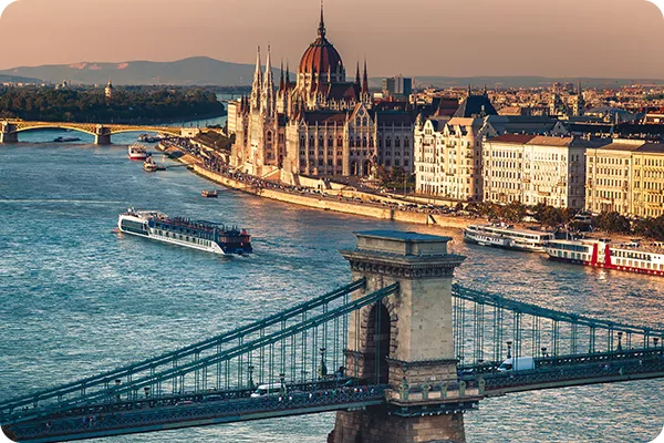 cruise ship on a river next to a city