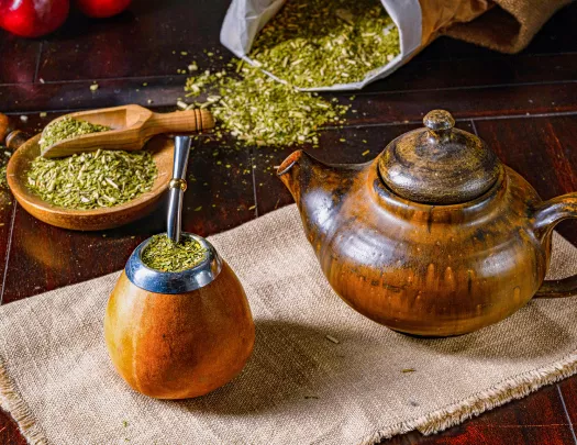 A cup and tea put full of traditional mate drink