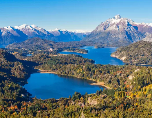 Multiple lakes surrounded by tall trees and mountains