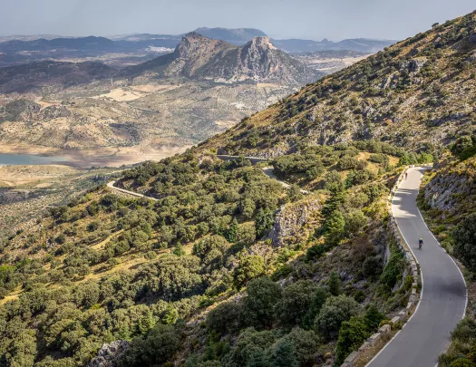 Two Backroads' guests biking on road in mountains, Spain.