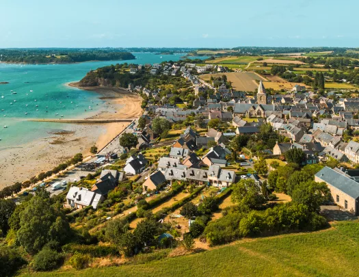Rustic homes by the oceanside, with large crop valleys in the distance