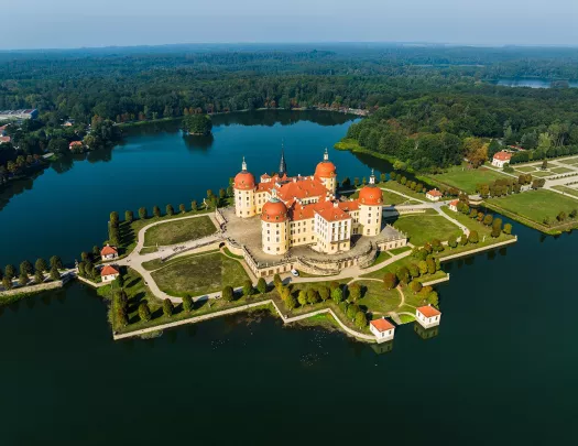 Large, palace-like building in a small peninsula, surrounded by water