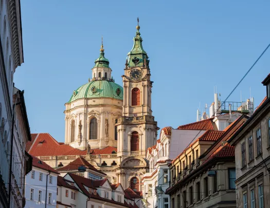 Large, castle-like building in the distance of a small town