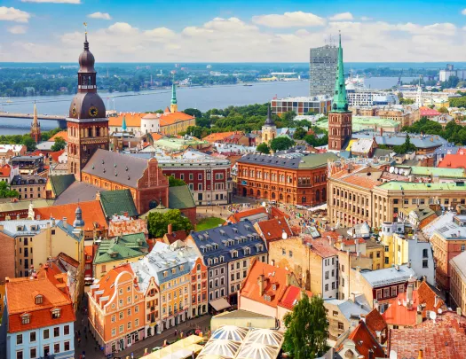 Sky view of a European town with orange apartment building and a large river in the background