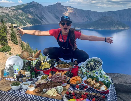 Leader standing above lunch table, gesturing to it.