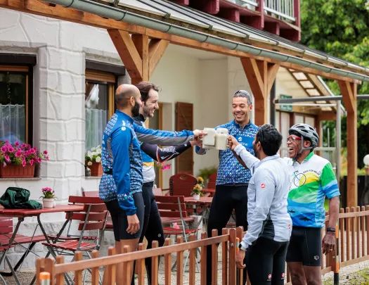 Group of men raiding beer steins and smiling