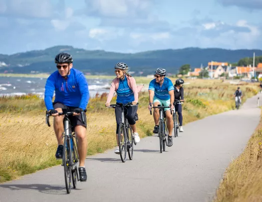 Guests biking along ocean path
