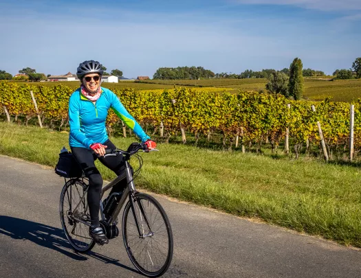 Backroads Guest Biking Past Field