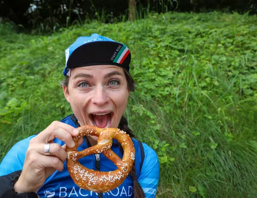 Backroads leader posing with soft pretzel.