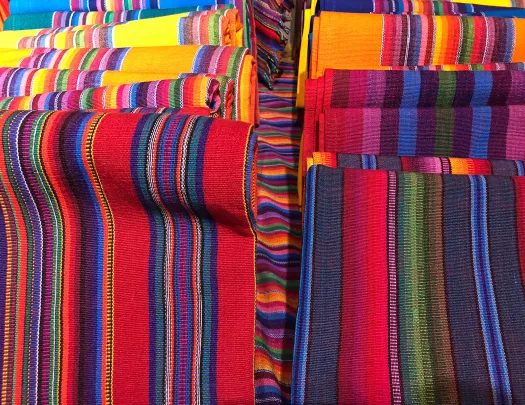 Colorful woven blankets rolled up