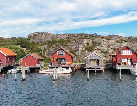 Row of red shacks on a dock by the water