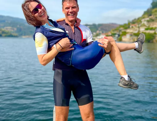 Two bikers posing on a dock in Portugal.