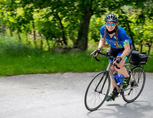 person biking in a backroads jersey