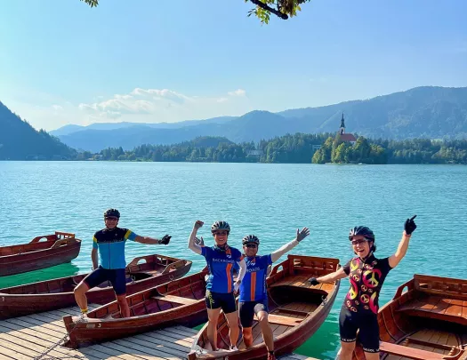 Group of people standing on wooden boats by a large lake