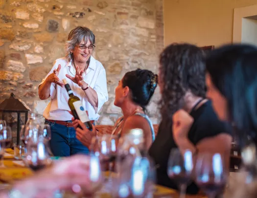 Four guests at dinner, talking wine with local.