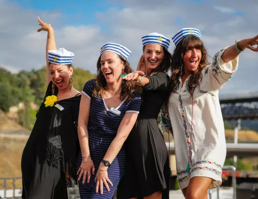 Group of 4 women smiling while wearing sailor hats