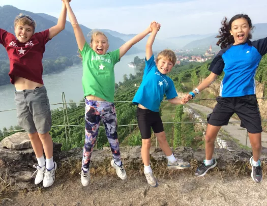 Kids jumping on a mountain