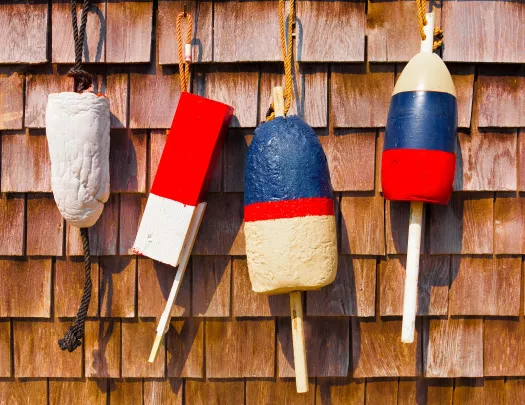 Four buoys hanging on a wooden wall