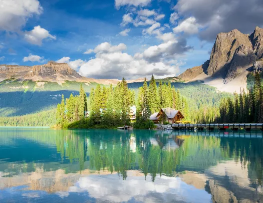 Cabin surrounded by a large lake and tall trees