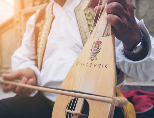 Close-up of local playing string instrument.