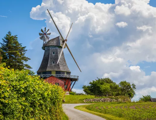 Windmill with dramatic clouds hovering over