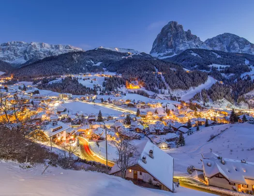 A small town covered in snow and lit up with lights