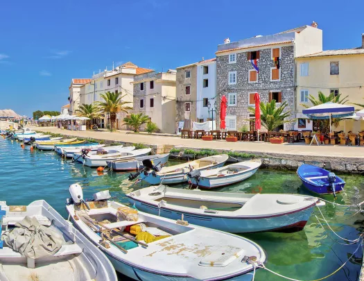 Boats docked by a row of houses