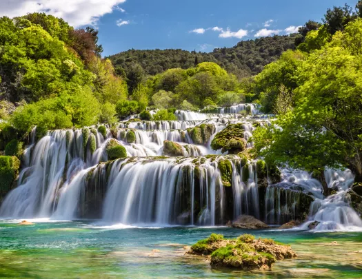 Large waterfall with a forest in the background
