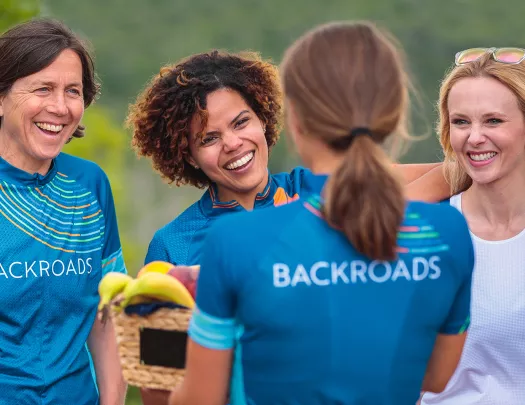 Four guests in BR gear, all smiling, talking.