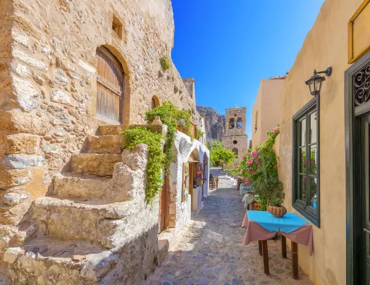 POV shot of someone walking down beachy stone alleyway.