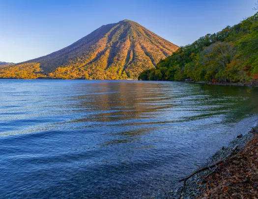 A placid lake with a mountain in the background