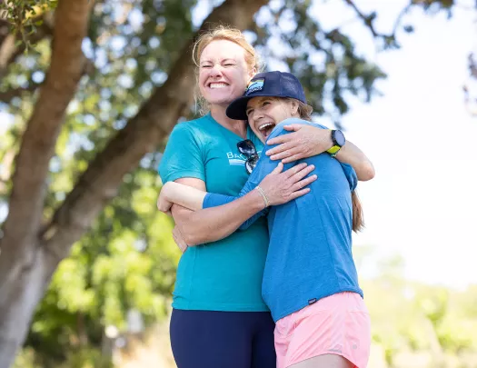 Two women hugging each other