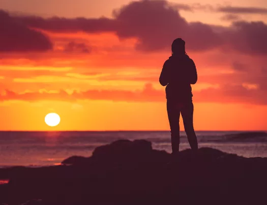 Backlit hiker at sunset.