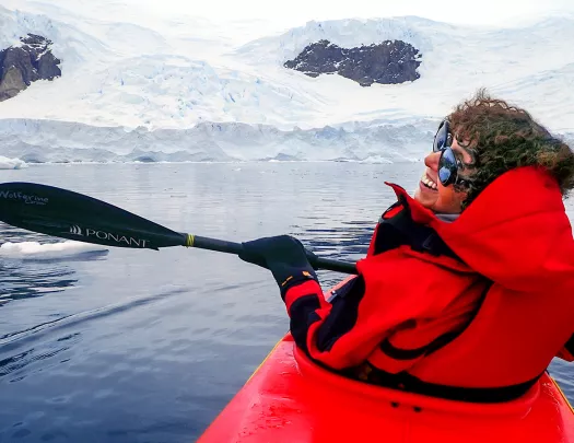 Person kayaking in the icy waters of Antarctica
