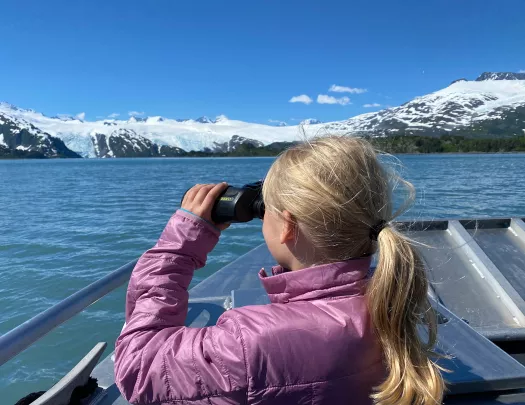 Child with binoculars on boat