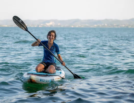 Person paddle boarding in the middle of the ocean