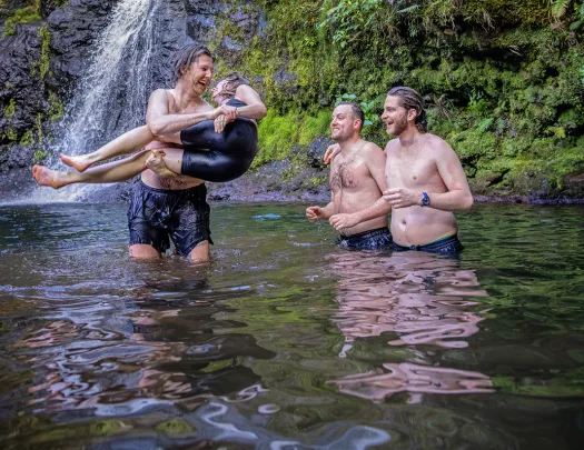 Guests Enjoying Pond in Front of Waterfall