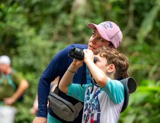 Mom and son looking through a pair of binoculars