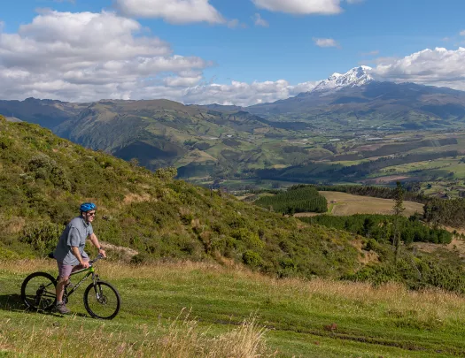 Biker cycling across a large field