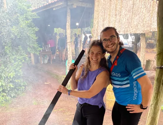 Two people stir a large pot