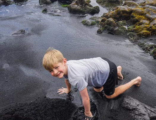 Child playing in a pool of water in Hawaii