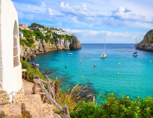 Coastside cliff with boats floating in the ocean