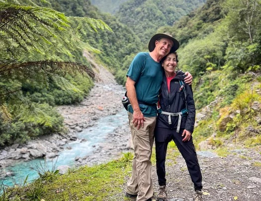 Two people posing next to a stream in New Zealand