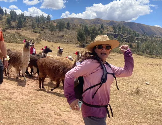 Guest running with alpaca herd.