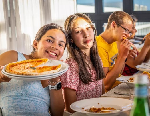 Teenagers eating handmade pizza in Portugal