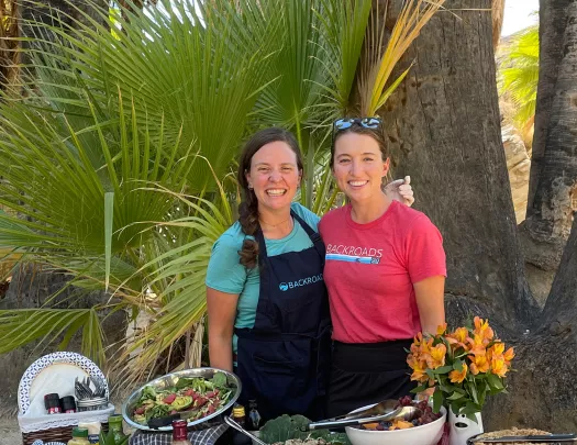 Guest and leader with prepped lunch spread.