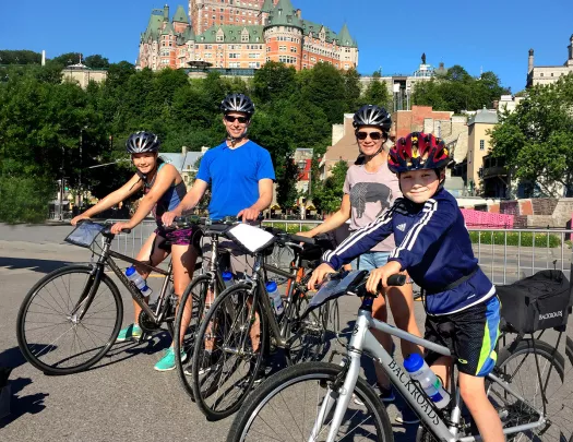 Guest family on their bikes, Fairmont Le Château Frontenac in background.