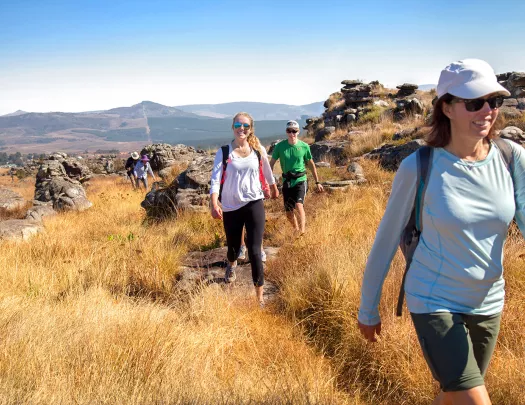 Hikers smiling along trail in Africa