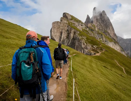 Hikers walking trail towards mountain